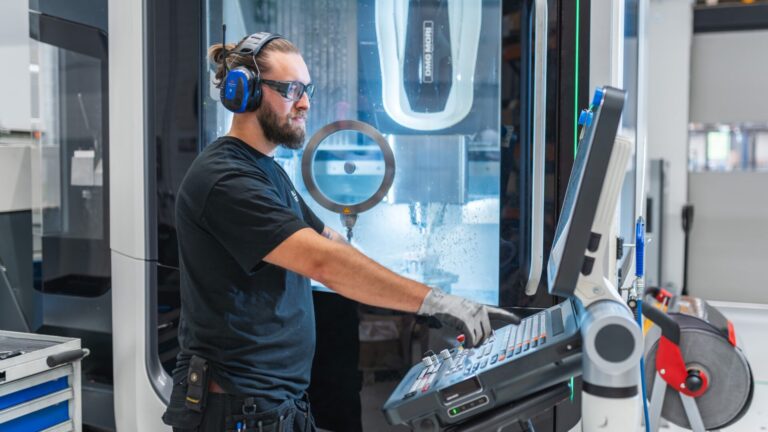Workshop employee operating a CNC machine